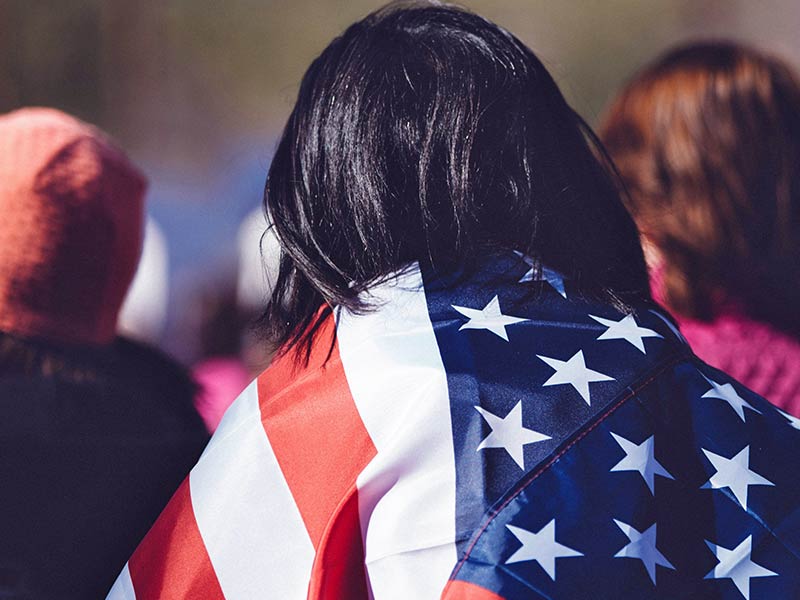 Person Carrying American Flag over their Back 1